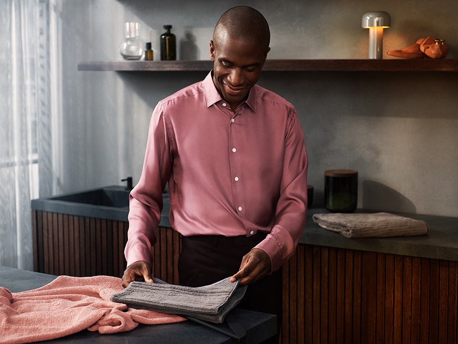 man folding towels